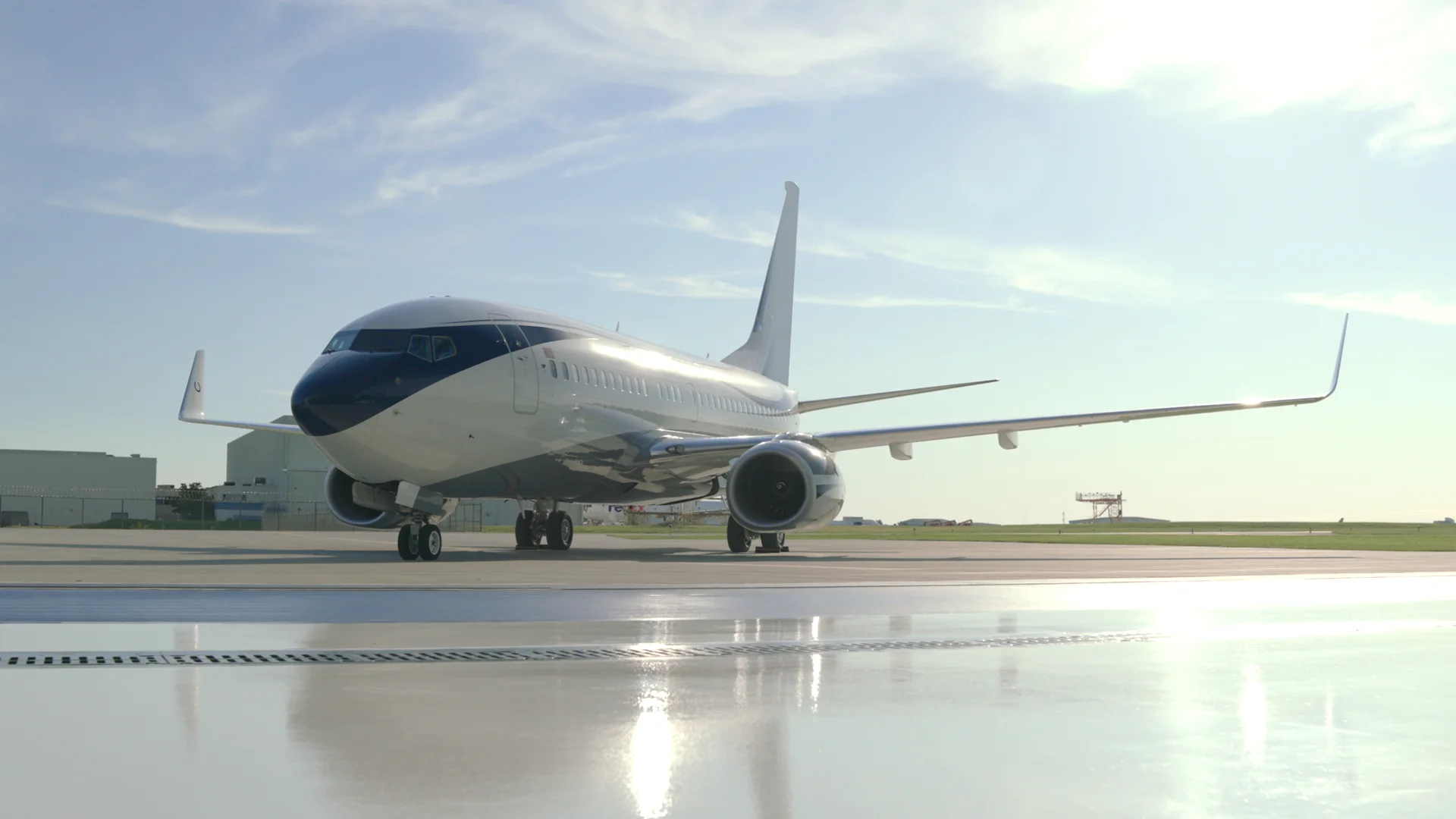 Boeing Business Jet on the apron in sunlight
